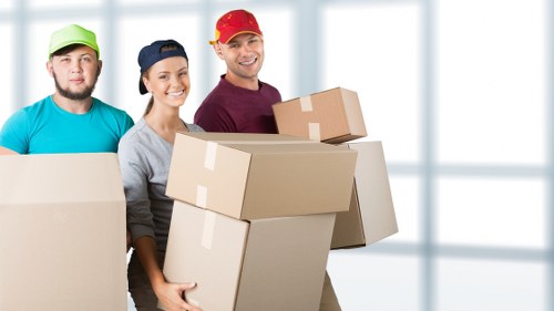 Moving team handling boxes and furniture in a South London street