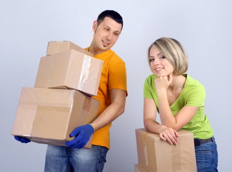Local moving team handling boxes in a Lambeth flat